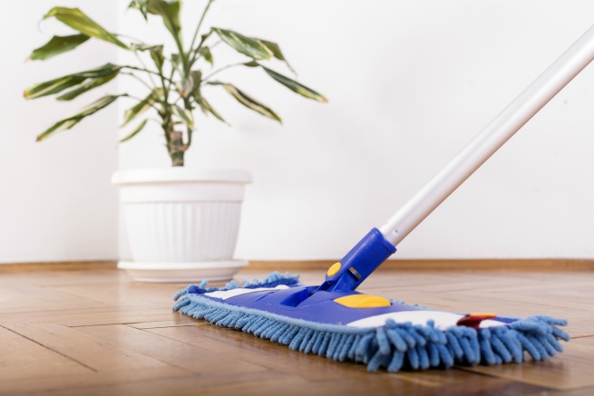 An image showing somebody clean the floors with a mop