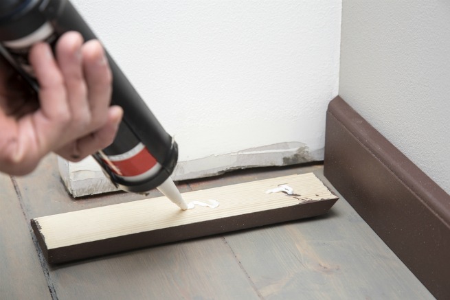 Image of someone fitting skirting boards