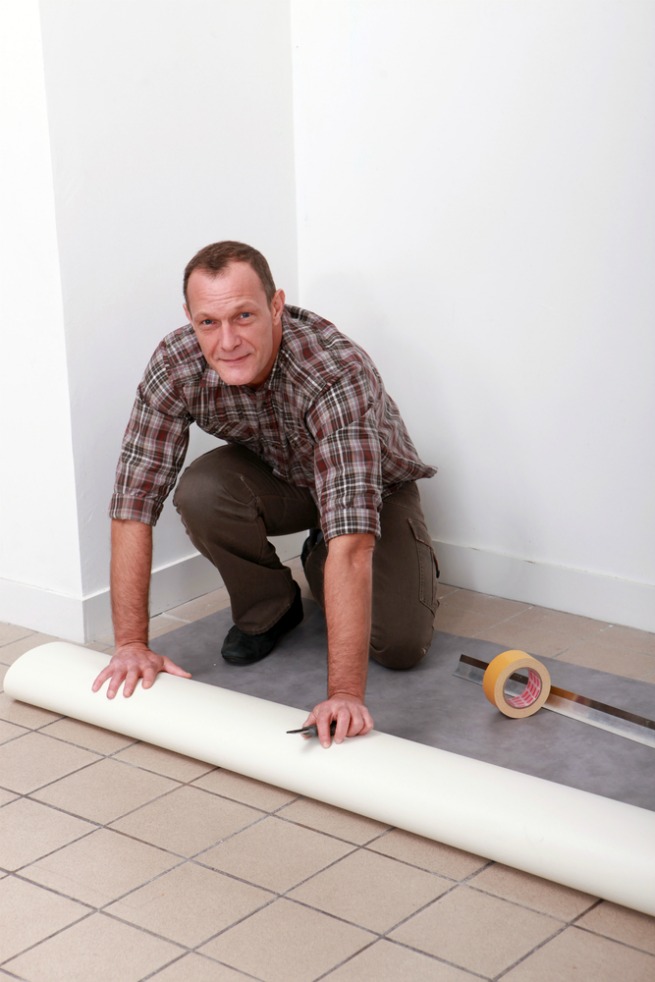 Image of a man laying vinyl